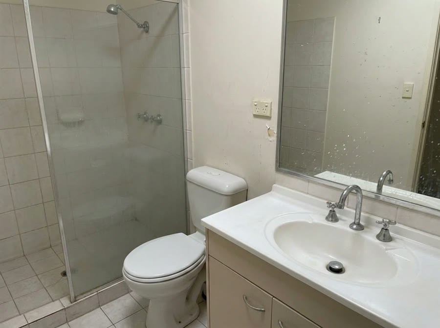 Bathroom with soap scum and limescale before cleaning