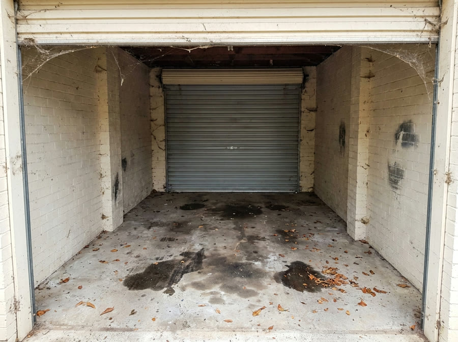 Garage floor with oil stains before cleaning
